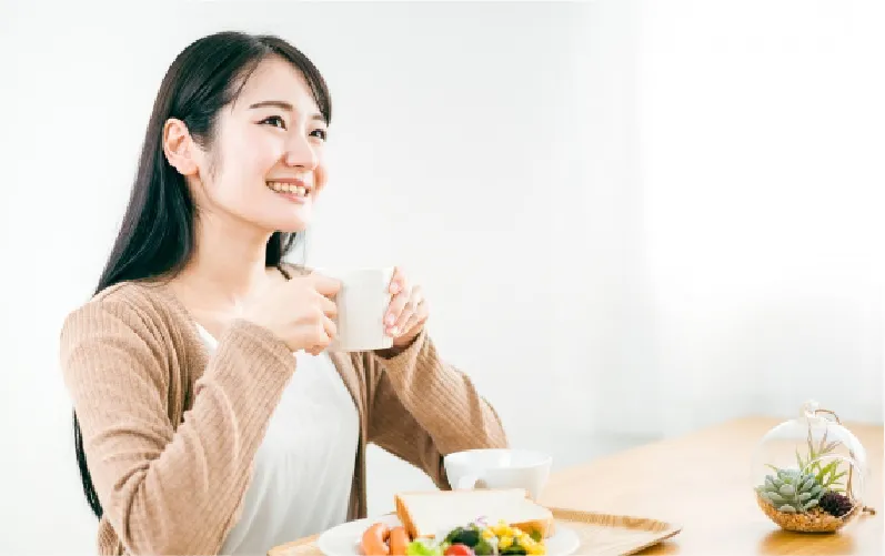 コップを持って笑っている女性